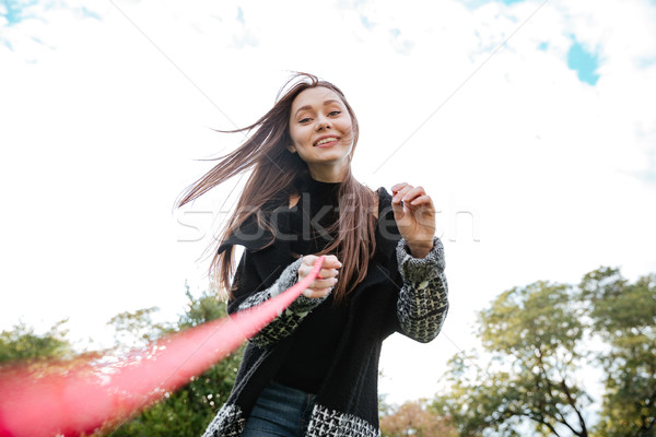 Smiling pretty young woman running with dog Stock photo © deandrobot