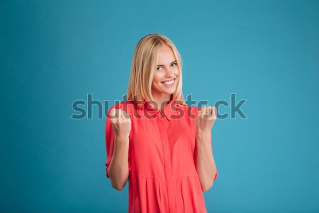 Beautiful woman in red dress posing and looking at camera Stock photo © deandrobot