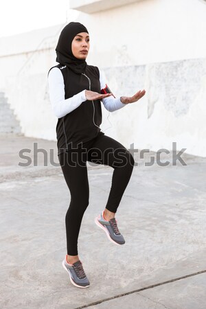 Modern young woman in black hat dancing and whirling Stock photo © deandrobot