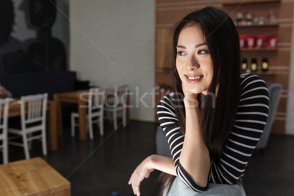 Pensive Smiling Asian woman sitting in cafeteria Stock photo © deandrobot