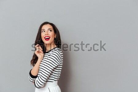 Pregnant woman talking on mobile phone and pointing finger up Stock photo © deandrobot