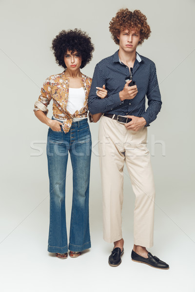 Serious retro loving couple standing and posing Stock photo © deandrobot