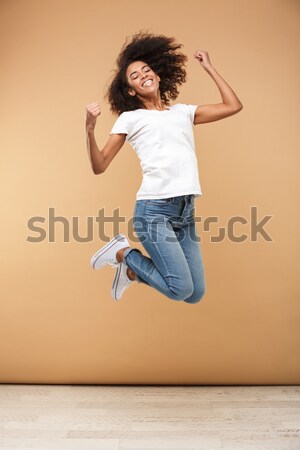 Full length portrait of adorable american woman with afro hairst Stock photo © deandrobot