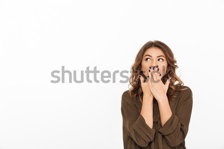 Portrait of a shocked young woman covering mouth Stock photo © deandrobot