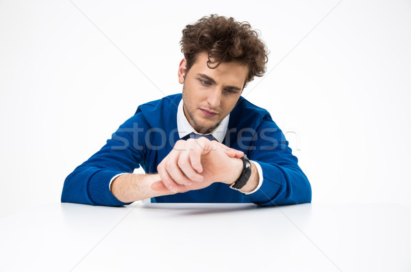 Handsome businessman looking at watch over white background Stock photo © deandrobot