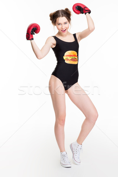 Happy attractive woman posing in black swimsut and boxing gloves  Stock photo © deandrobot