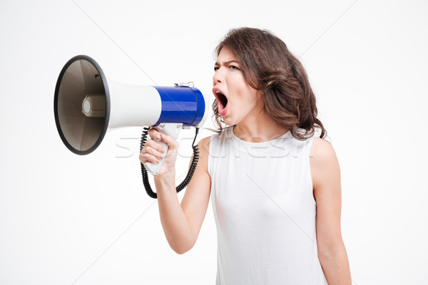 Young woman shouting into loudspeaker Stock photo © deandrobot