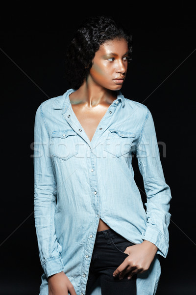 Confident african young woman with shining makeup standing and posing Stock photo © deandrobot
