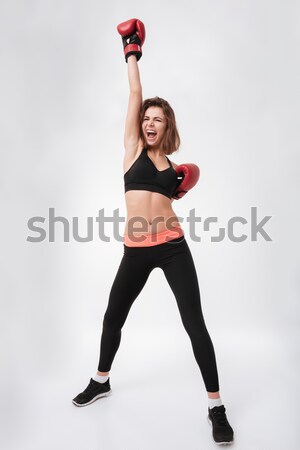 Full length portrait of a motivated muscular sportswoman Stock photo © deandrobot