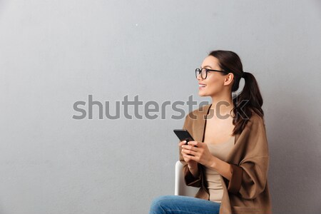 Portrait of a happy casual asian woman Stock photo © deandrobot