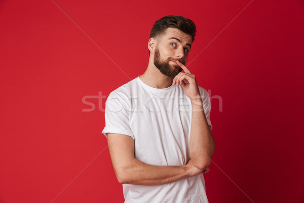 Thinking young handsome man looking aside. Stock photo © deandrobot