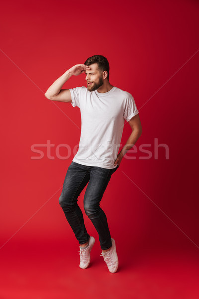 Handsome concentrated young man looking aside. Stock photo © deandrobot