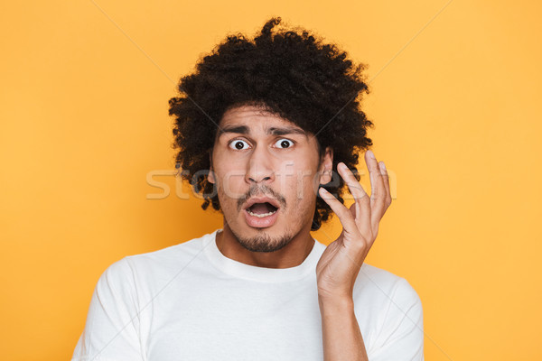 Portrait of an astonished young african guy Stock photo © deandrobot