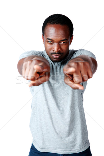 Handsome african man pointing at you over white background Stock photo © deandrobot