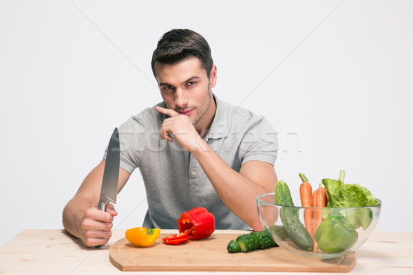 Handsome man preparing salad Stock photo © deandrobot