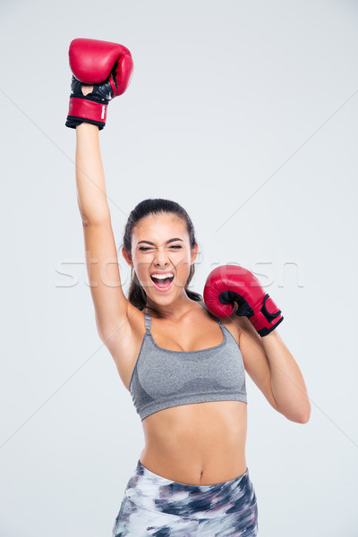 Fitness woman with boxing gloves celebrating her victory Stock photo © deandrobot