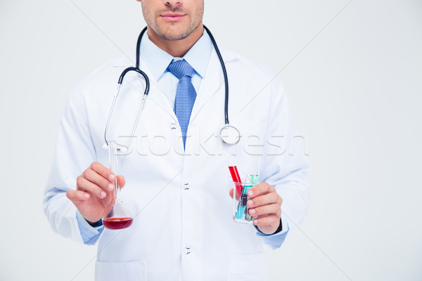 Male doctor holding tube with liquid  Stock photo © deandrobot