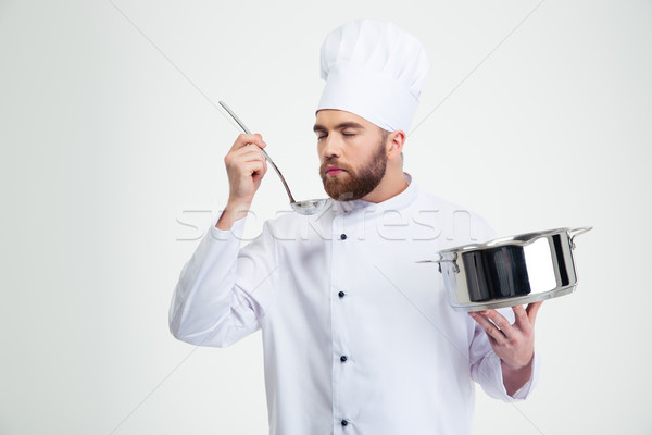 Male chef cook holding a saucepan and ladle  Stock photo © deandrobot