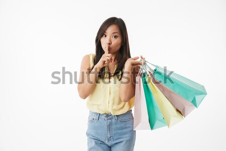 Woman holding shopping bags and talking on the phone Stock photo © deandrobot