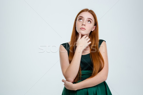 Portrait of a pensive woman looking up Stock photo © deandrobot