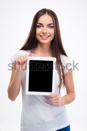 Cheerful charming young business woman holding blank screen tablet  Stock photo © deandrobot