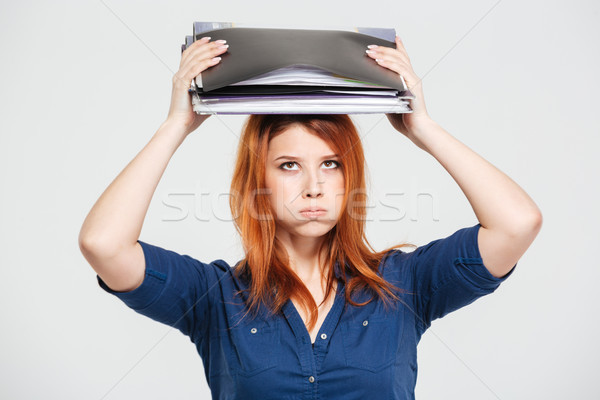 Exhausted overworked woman standing with folders on her head Stock photo © deandrobot