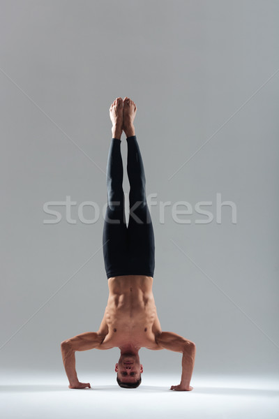 Man doing yoga headstand Stock photo © deandrobot