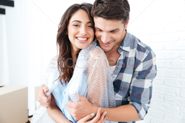 Young pretty couple moving in new flat Stock photo © deandrobot