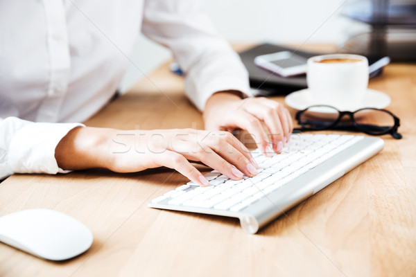 Cropped image of women's hands typing on keyboard Stock photo © deandrobot