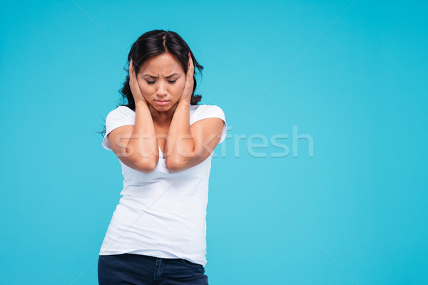 Beautiful young vietnamese woman covering her ears with palms Stock photo © deandrobot