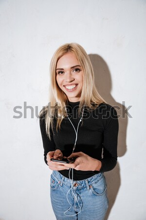 Stock photo: Cheerful brunette woman showing flat belly and looking at camera