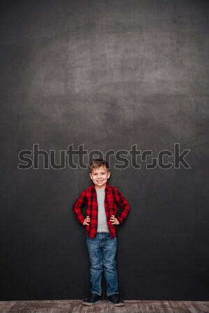 Cute little boy standing over chalkboard Stock photo © deandrobot