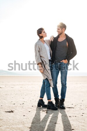 Happy tender young couple standing and hugging on the beach Stock photo © deandrobot