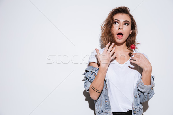 Shocked lady eating candy Stock photo © deandrobot