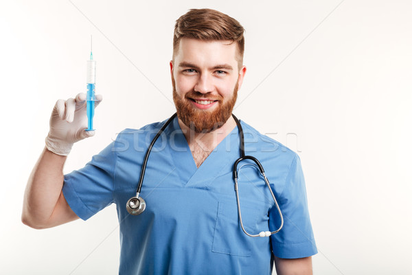 Portrait of a smiling happy medical doctor or nurse Stock photo © deandrobot