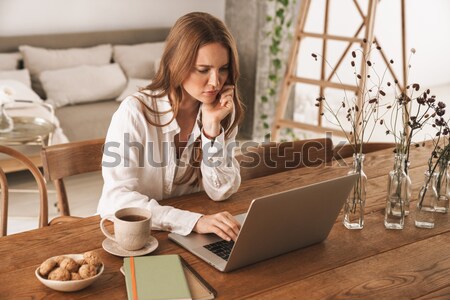 Stock photo: Pretty dreaming girl sitting at the cafe table