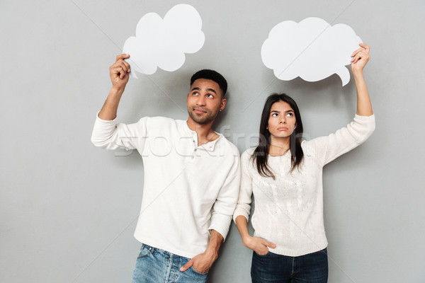 Upset couple with blank bubbles looking up Stock photo © deandrobot