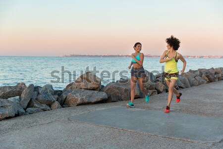 Stock photo: Side view of two fitness women running outdoors