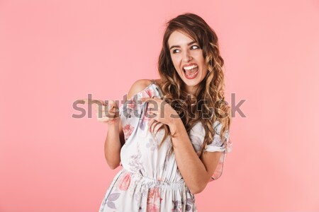 Close-up photo of joyful young woman with shiny makeup standing  Stock photo © deandrobot