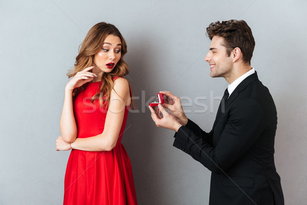 Stock photo: Portrait of a happy cheerful man showing box