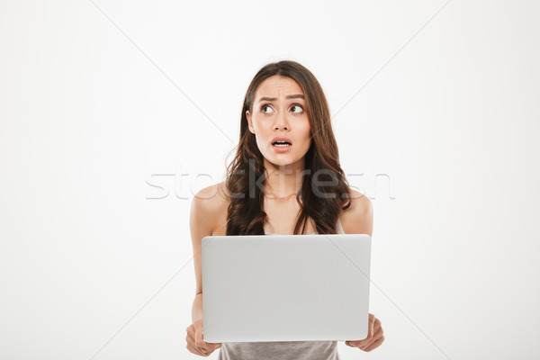 Image of young woman 30s looking away being stressed or disappoi Stock photo © deandrobot