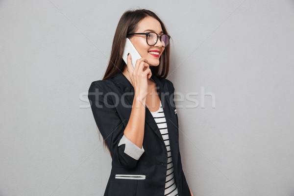 Stockfoto: Glimlachend · asian · zakenvrouw · bril · praten · smartphone