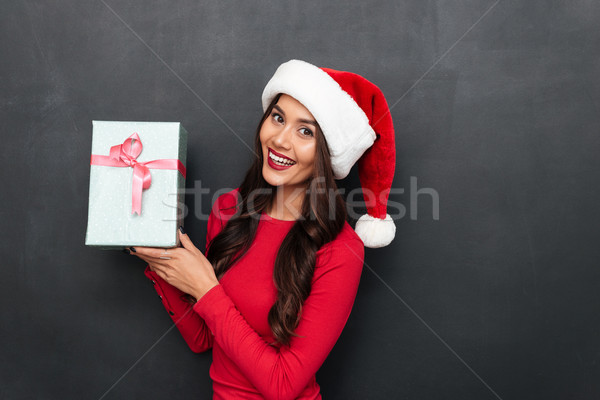 Happy brunette woman in red blouse and christmas hat Stock photo © deandrobot