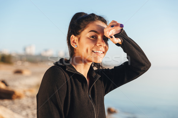 Pretty young sportsgirl at the seaside Stock photo © deandrobot