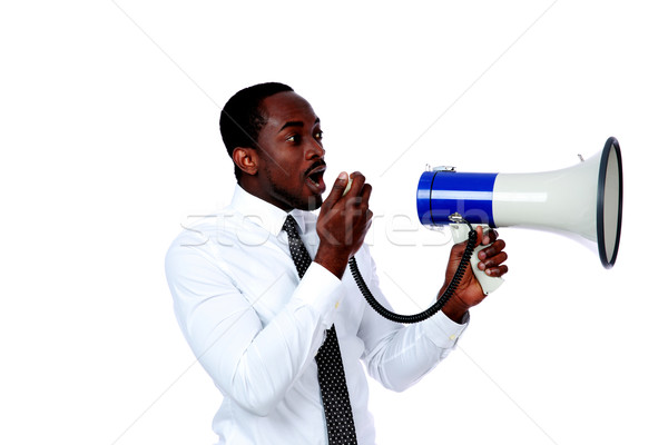 African man shouting through a megaphone isolated on a white background Stock photo © deandrobot