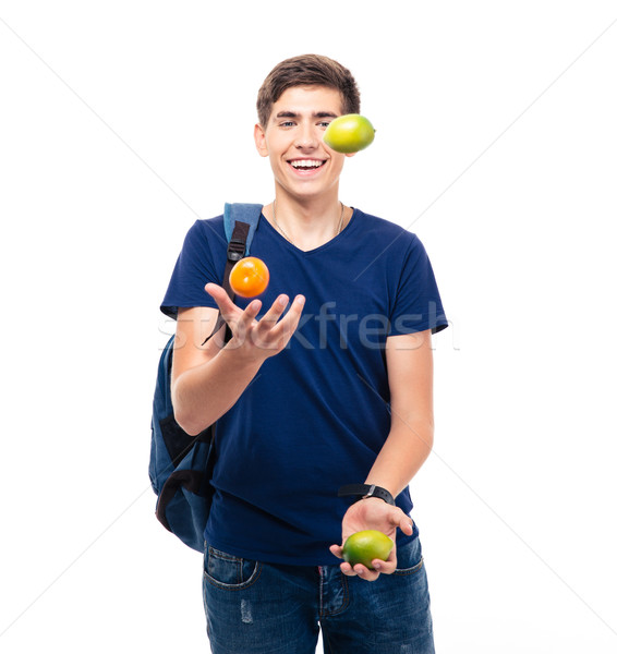 Casual young man juggles with fruits Stock photo © deandrobot