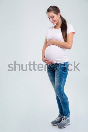 Pregnant woman caressing her belly  Stock photo © deandrobot