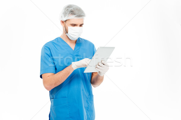Male surgeon using tablet computer  Stock photo © deandrobot