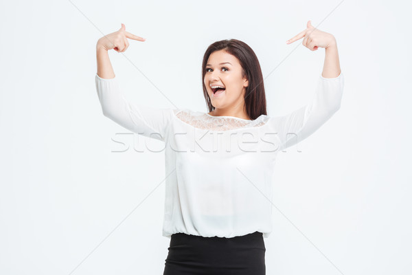 Cheerful businesswoman pointing finger at herself Stock photo © deandrobot