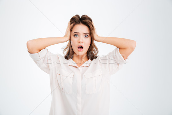 Woman covering ears and shouting Stock photo © deandrobot